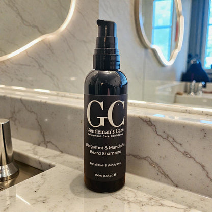 Bottle of Gentleman's Care beard shampoo on a marble bathroom counter